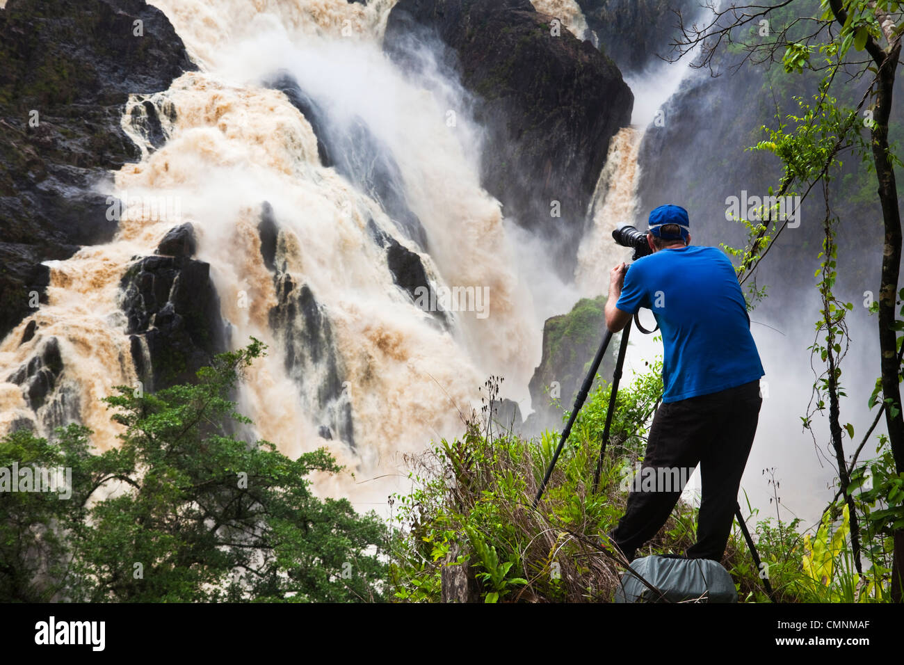 Man photographing Barron Falls during the rainy season. Kuranda, Cairns, Queensland, Australia Stock Photo