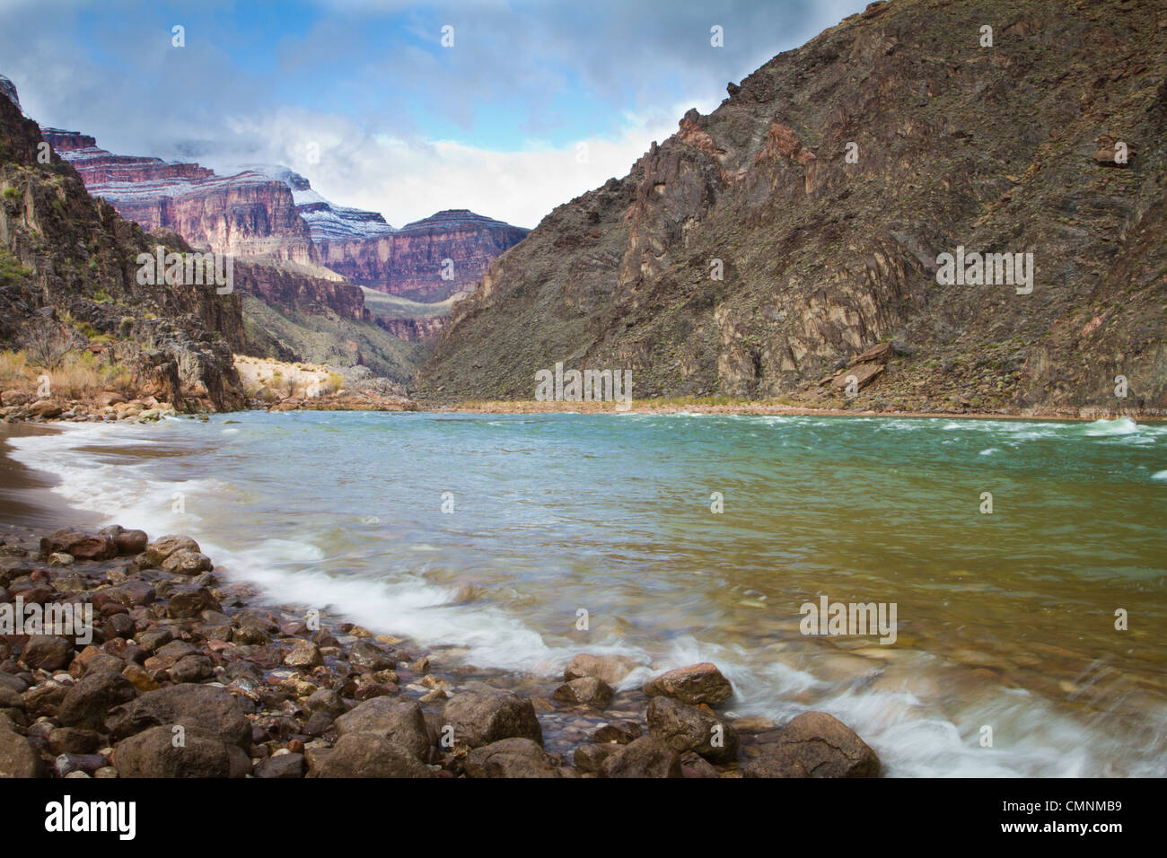 A storm clears over the Colorado River as it flows through Grand Canyon