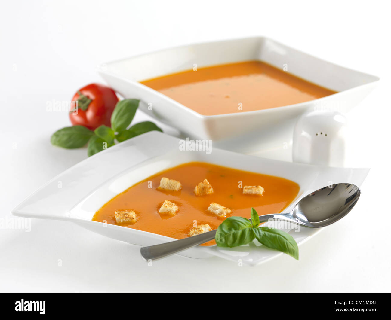 Delicious tomato soup with basil. Hot and cold can be consumed. The photo was taken is photo studio.  Great for menu card! Stock Photo