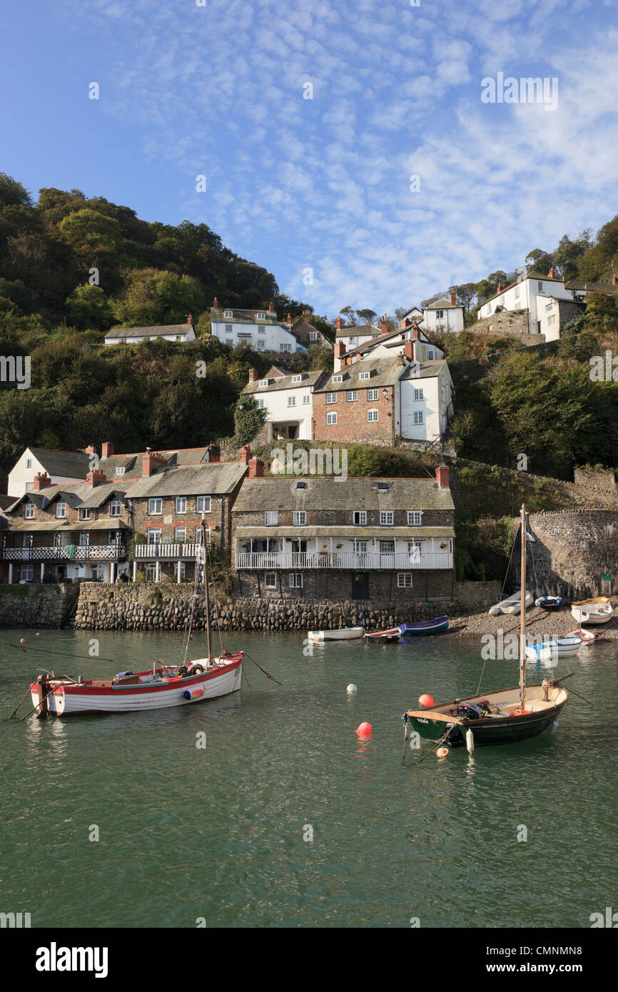 Clovelly, North Devon, England, UK. View of boats in the harbour below the village on a steep hillside on the coast Stock Photo