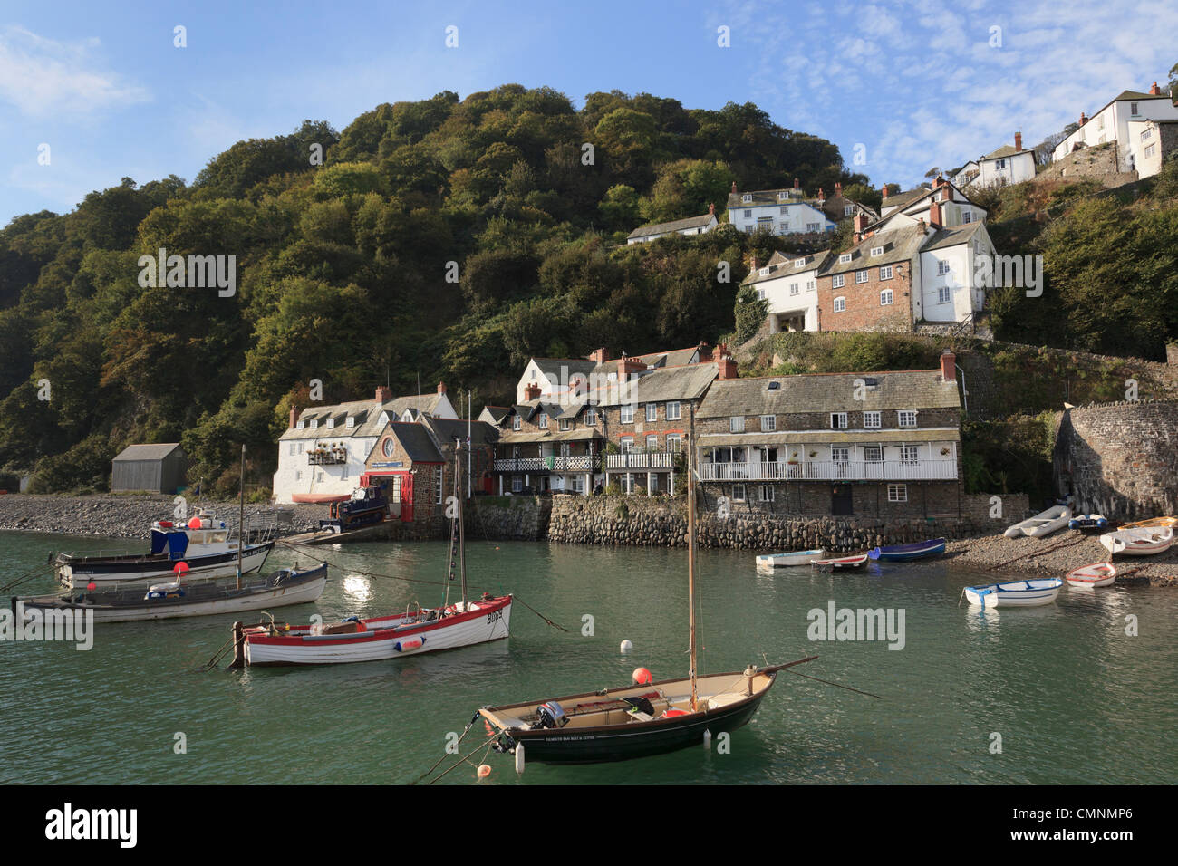 Coastal scene with boats in the harbour below the village on a steep hillside. Clovelly, Devon, England, UK, Britain Stock Photo