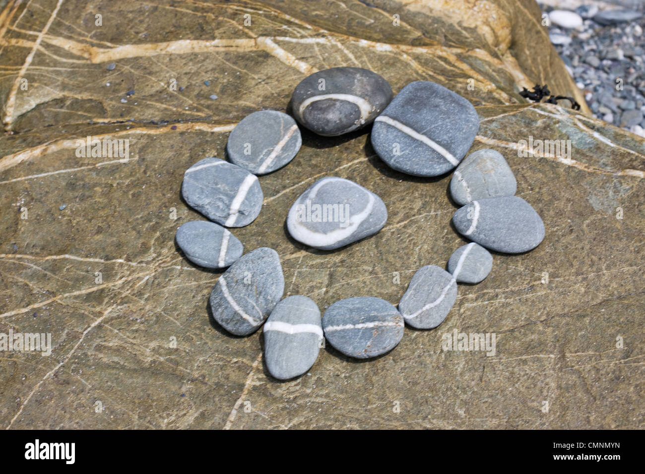 Circle of pebbles with a white line, circle of stones Stock Photo
