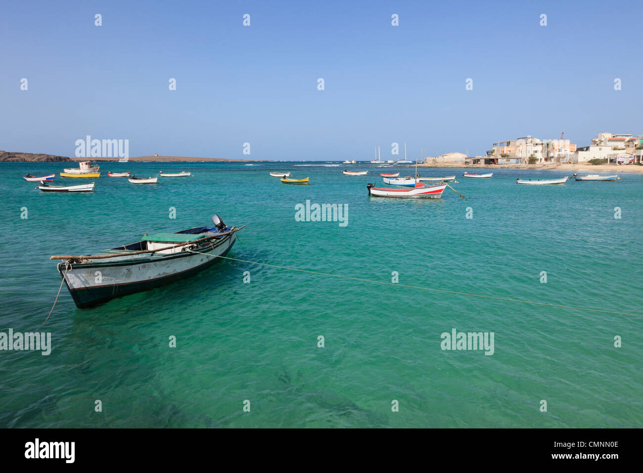 View across the harbour with small fishing boats moored in the turquoise sea. Sal Rei, Boa Vista, Cape Verde Islands, Africa Stock Photo
