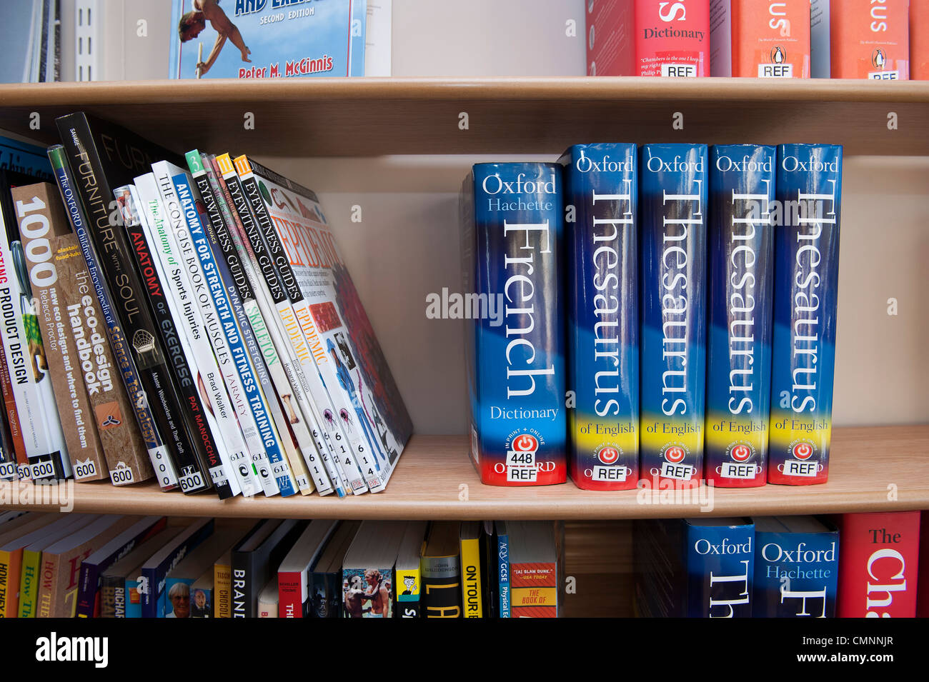 A book shelf in a UK school containing a French dictionary and a Theasaurus Stock Photo Alamy