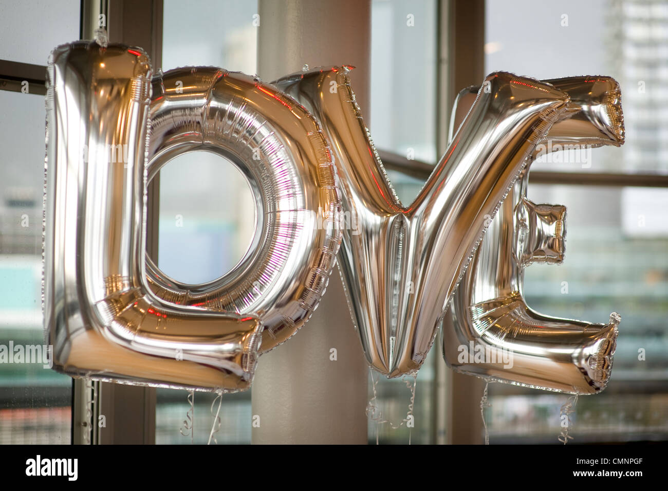 four balloons spelling the word love Stock Photo