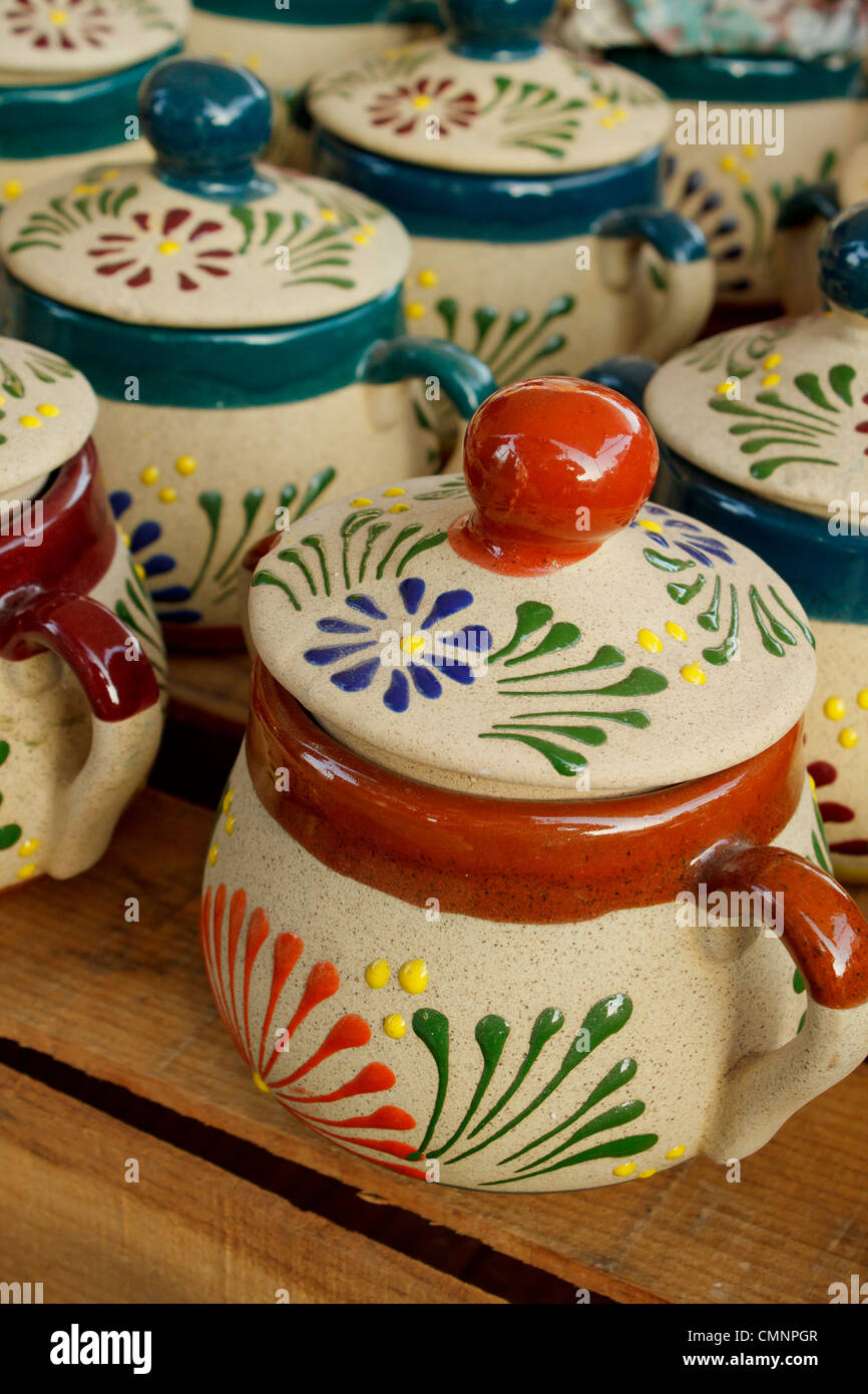 Variety of colorful handmade ceramic pots at outdoor market in Mexico. Stock Photo