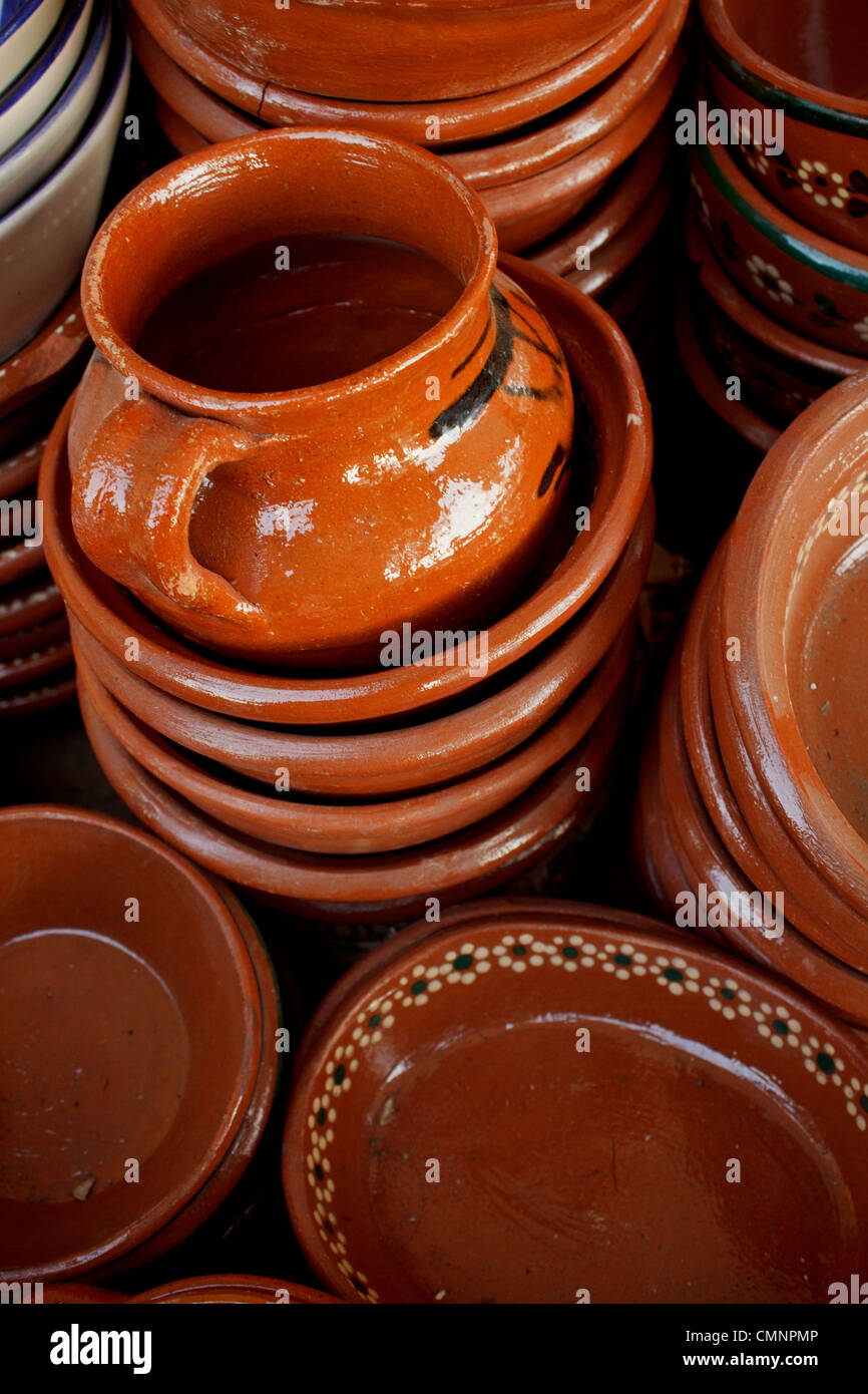 Variety of handmade clay pots at outdoor market in Mexico. Stock Photo