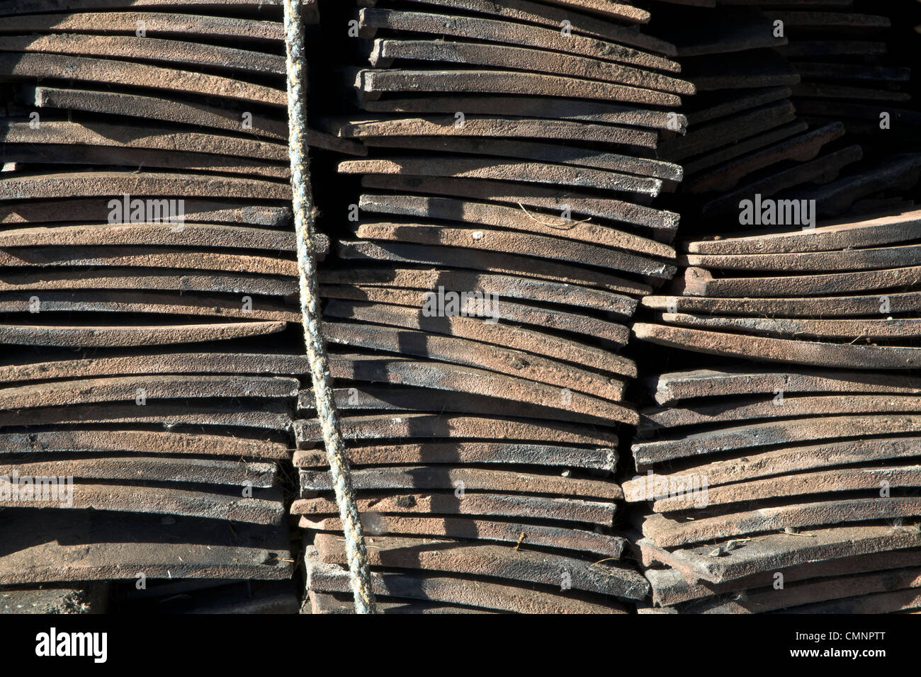 Stacks of roofing tiles in bright light, Craster, Northumberland. Stock Photo
