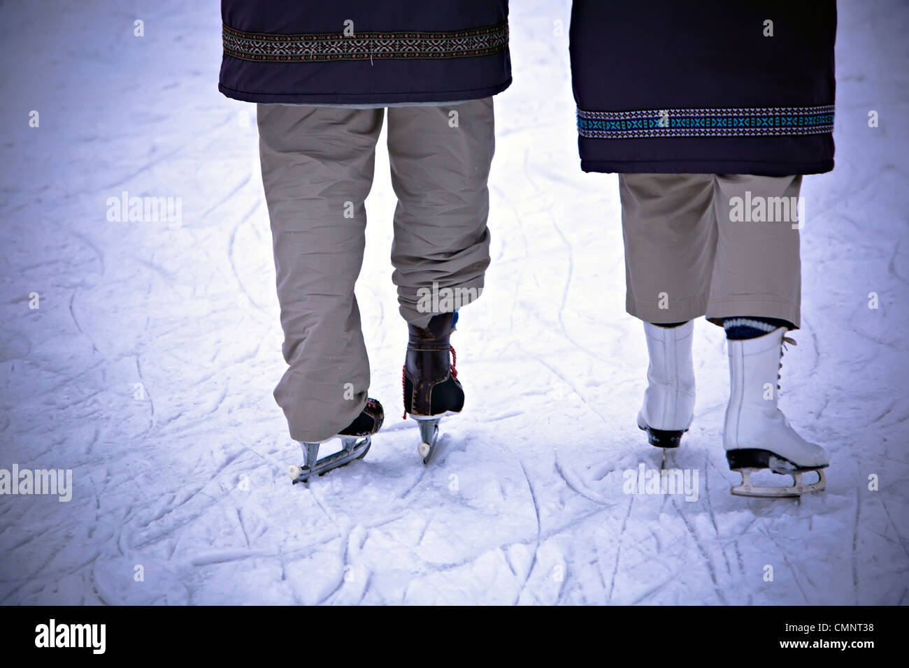 Elderly couple skating on Assiniboine River Trail, world's longest naturally frozen ice skating trail, The Forks, Winnipeg, MB Stock Photo