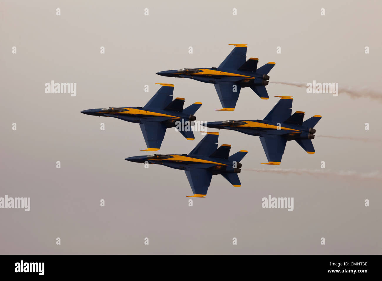 US Navy Blue Angle air superiority F-18 Hornet jet fighter. Close diamond formation against storm cloud. Stock Photo