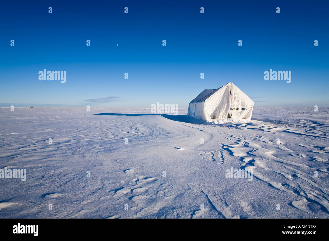 Ice fishing tent at sunset on