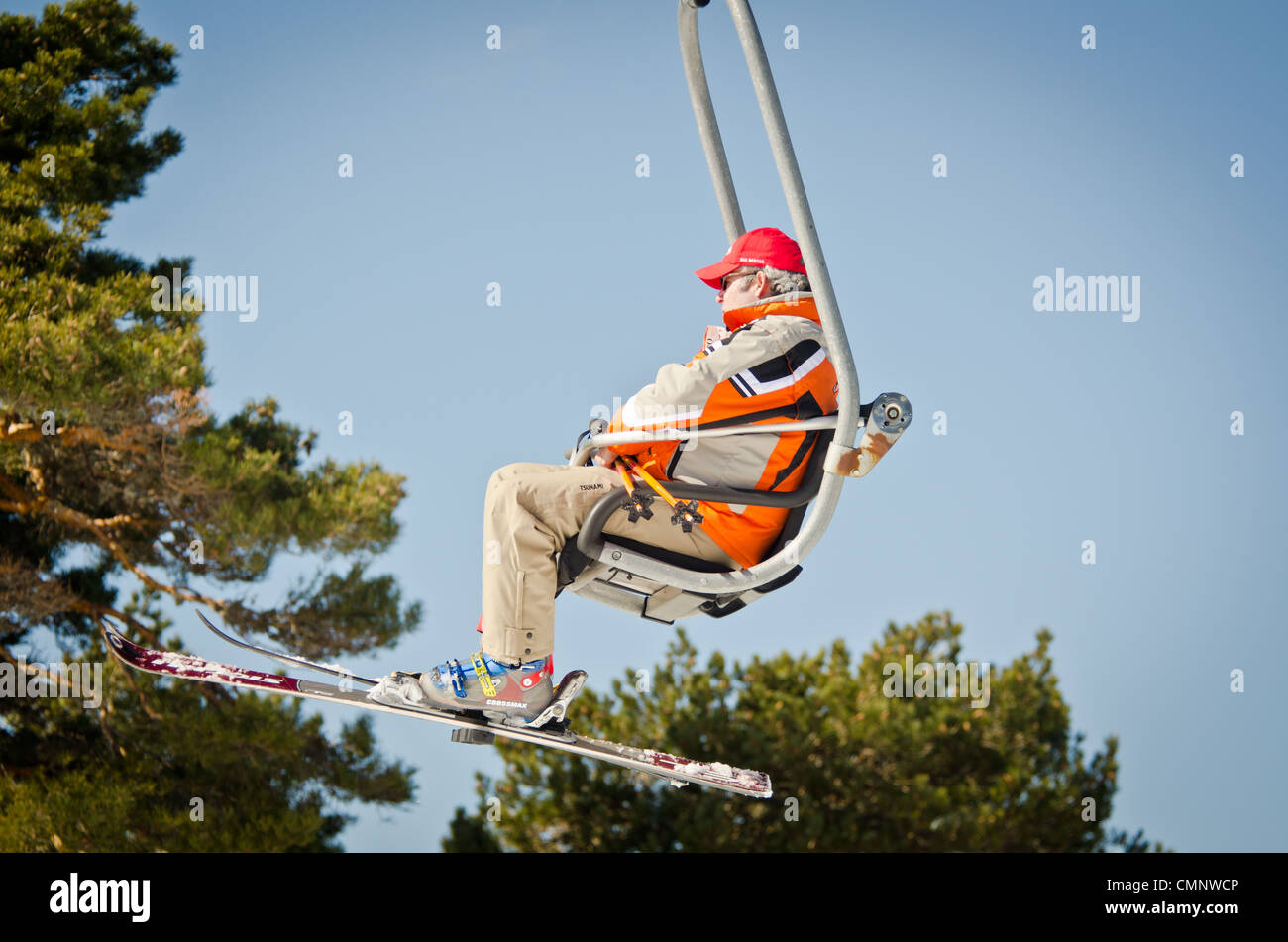 Skier on chair lift Stock Photo Alamy