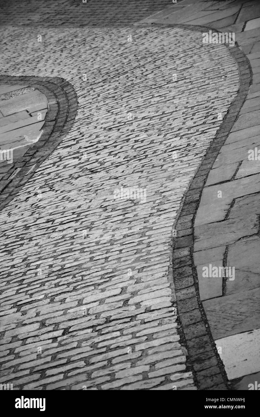 An old brick paved granite cobbled pavement footpath pedestrianized street in Lewes, East Sussex, England Stock Photo