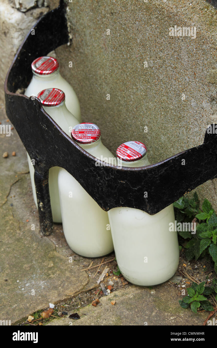 Glass bottles of delivered fresh milk on the street outside the front