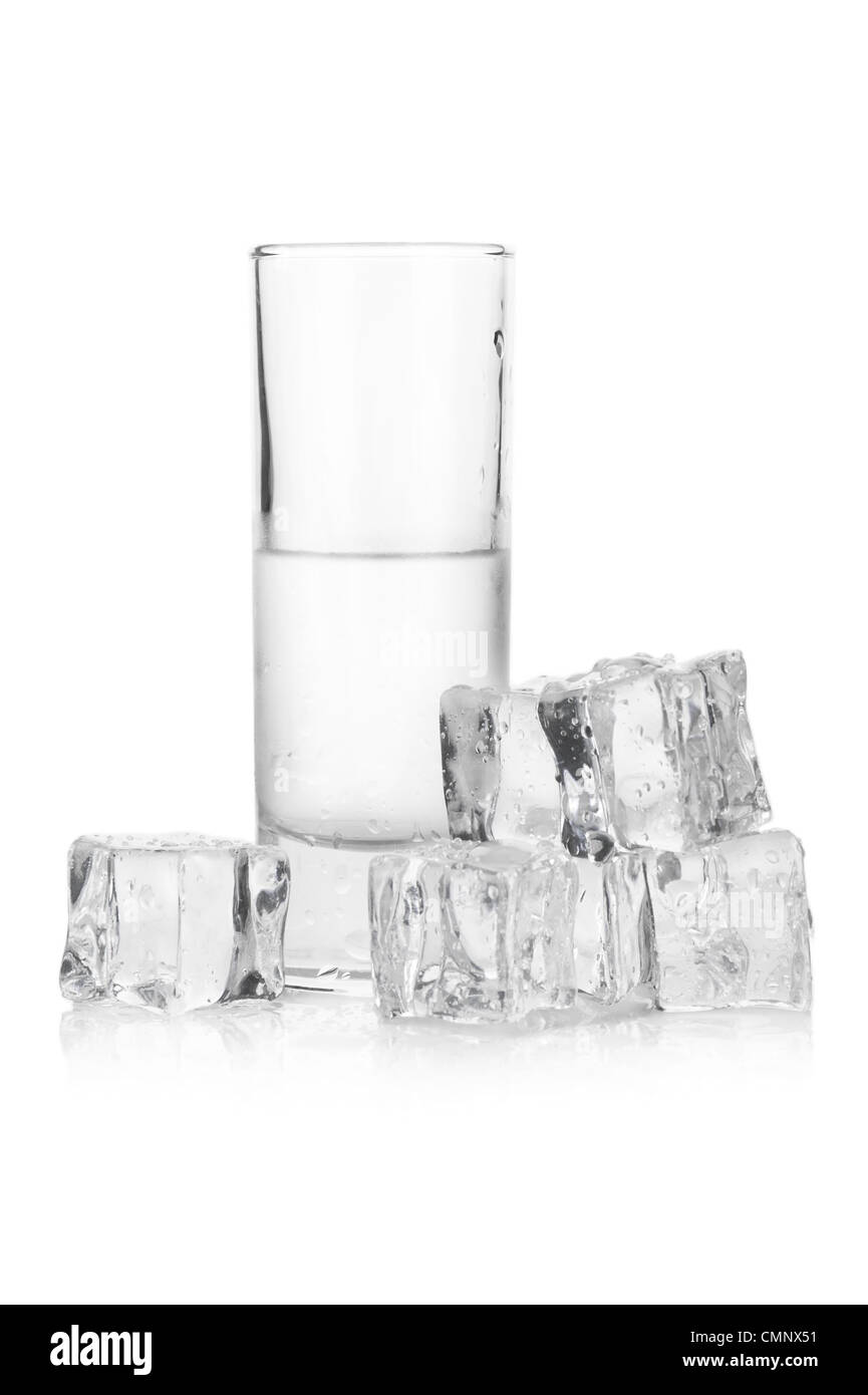 Frozen glass of iced vodka with ice cubes on white background Stock Photo