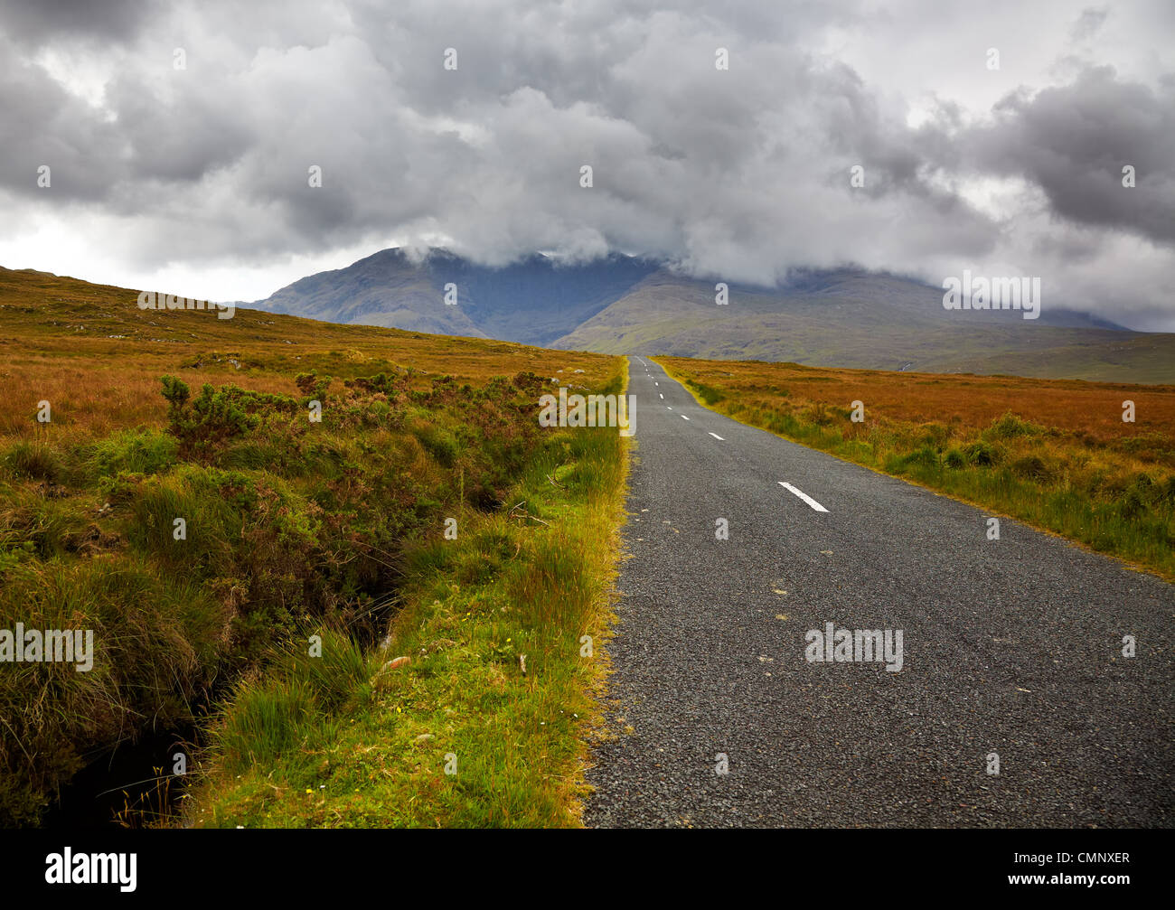Road in the countryside towards Sheefry hills in summertime, county Mayo, Ireland. Stock Photo