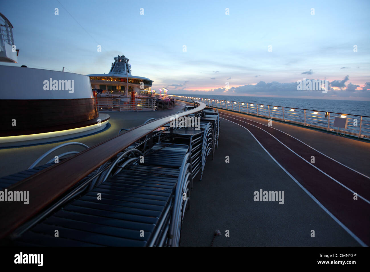 Top deck of large cruise liner, independence of the seas, Royal Caribbean lines with sunset in background Stock Photo