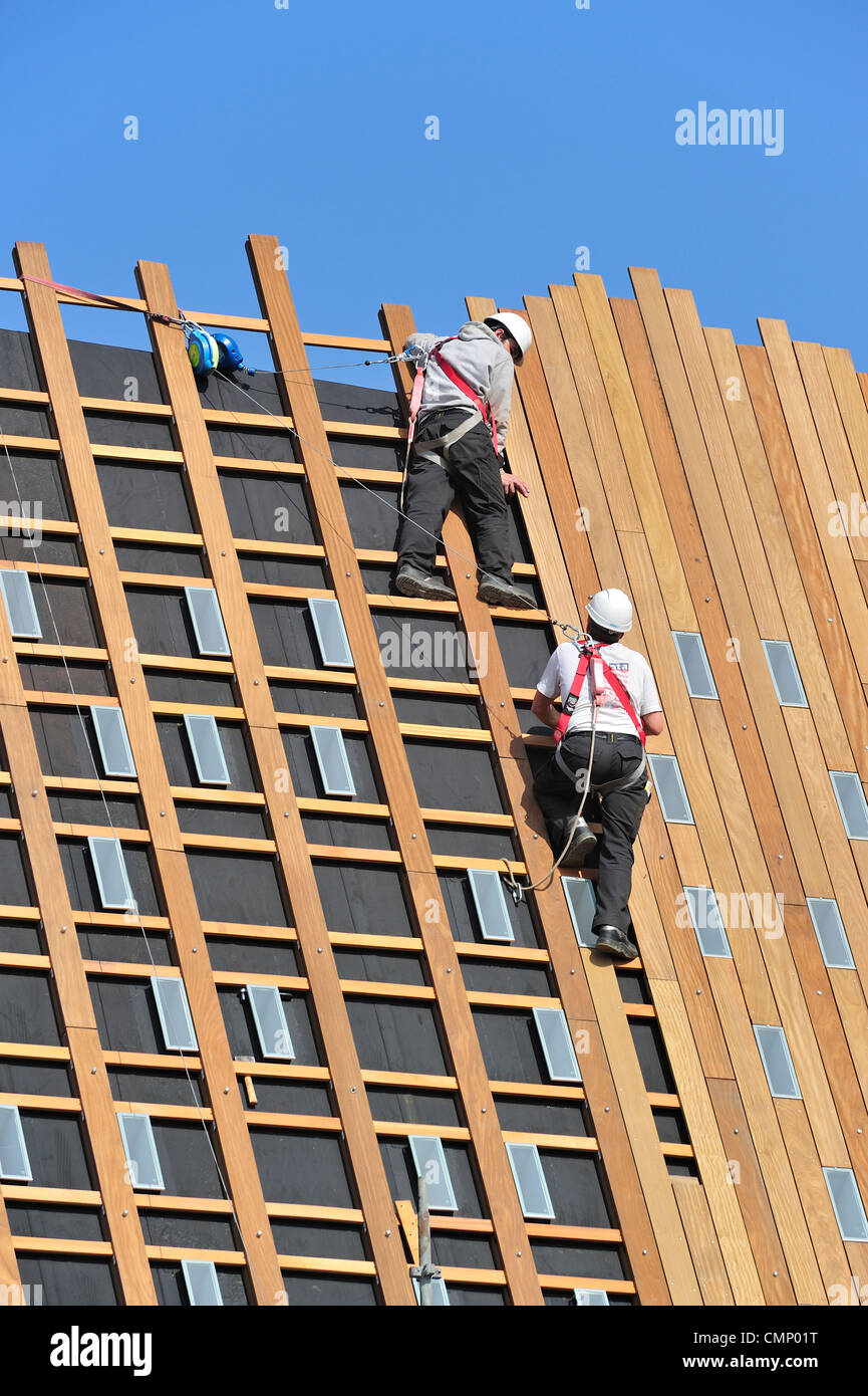 Roofers Ropes Construction workers / steeplejacks / roofers protected by safety ...