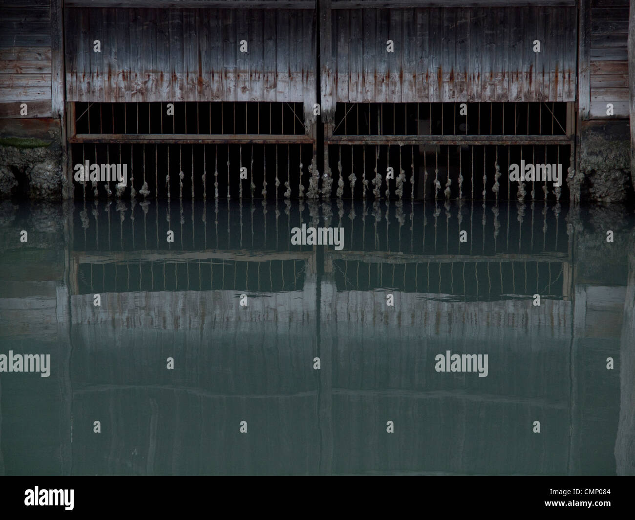 Reflections in the still waters of a Venetian canal Stock Photo - Alamy