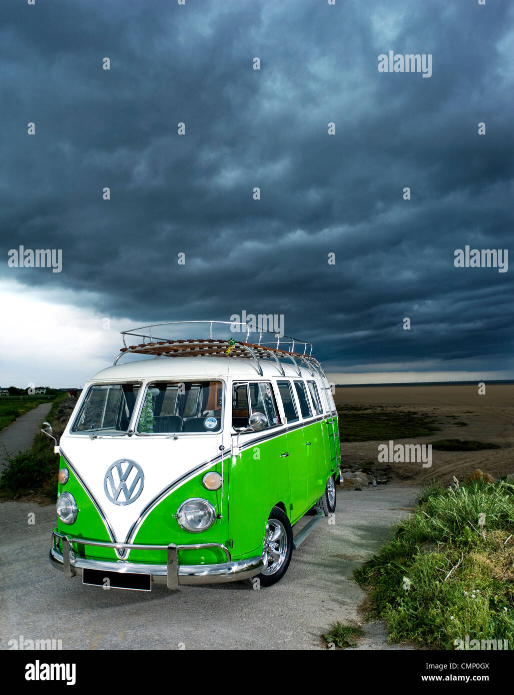 green vw volkswagen split screen camper van bus hippie hippy 1960s 1950s aircooled retro beach british rain cloudy bad weather Stock Photo