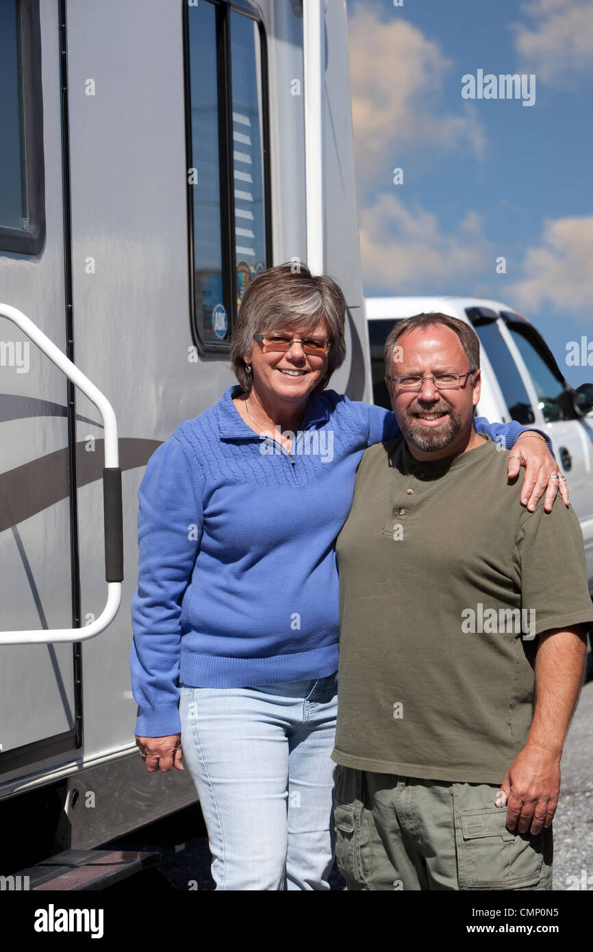 Retired couple alongside their trailer home Stock Photo