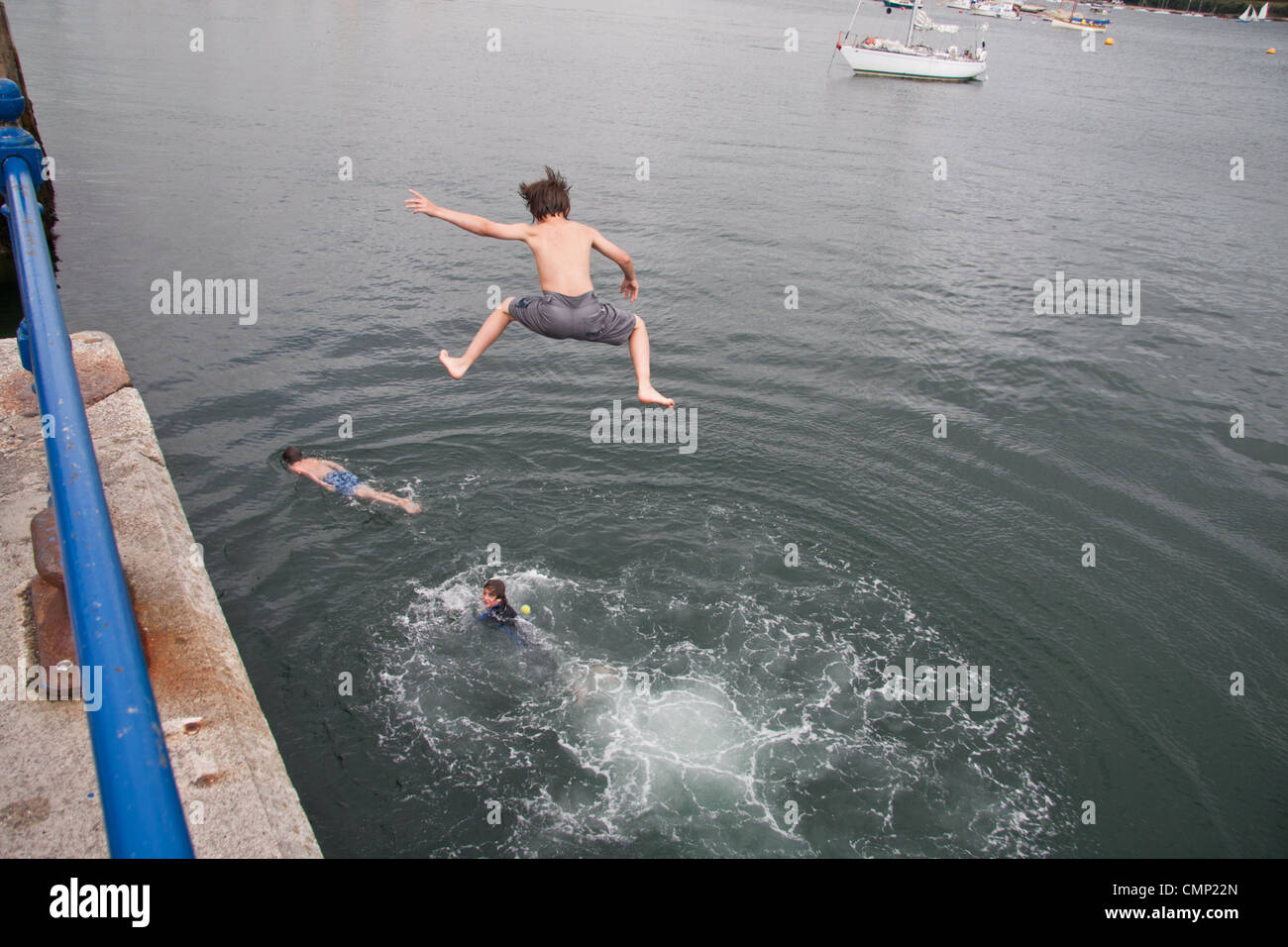 Boys diving from the quayside at Falmouth's Custom House Quay Stock