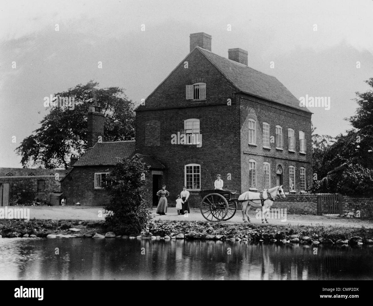 Ashmore Farm, Wednesfield, circa 1910. Two women and a girl stand next