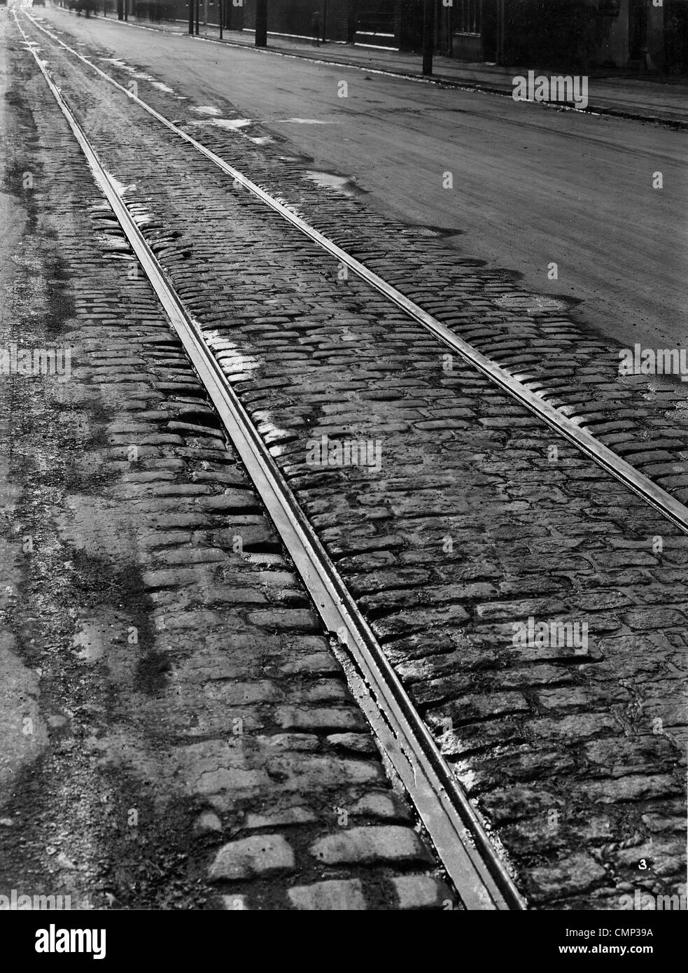 Tramlines, Willenhall Road, Wolverhampton, Early 20th cent. Tramlines showing some damage (foreground) on the partly cobbled Stock Photo