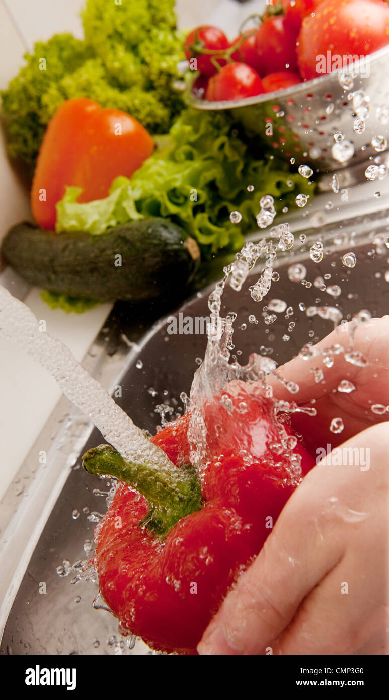 Fresh vegetables splashing in water before cooking Stock Photo