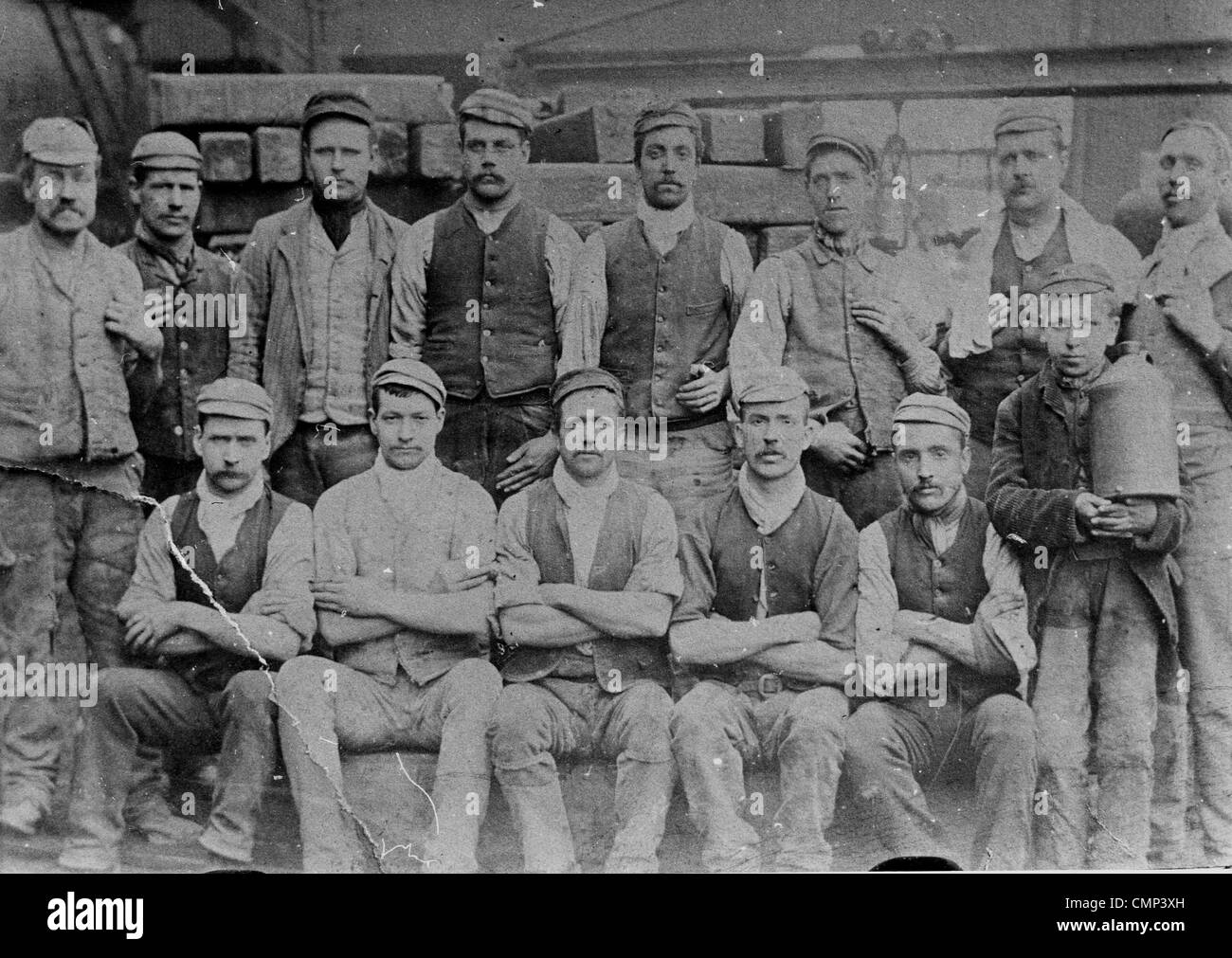 Gas Engine Workers, Wolverhampton, 1901. A group of gas engine workers. Note the child worker. The exact location is unknown. Stock Photo