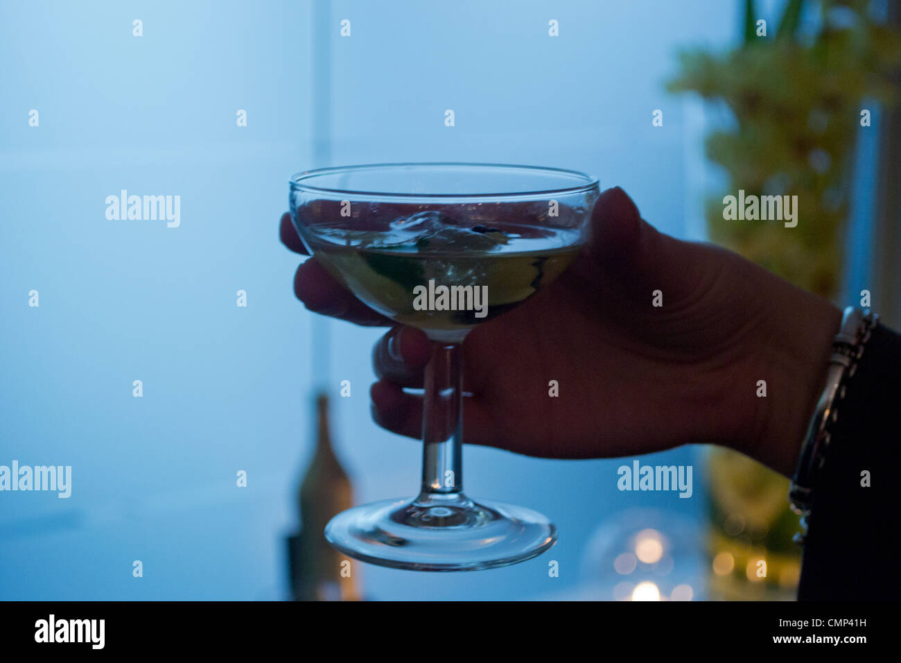 Raising a toast with a Martini cocktail. Stock Photo