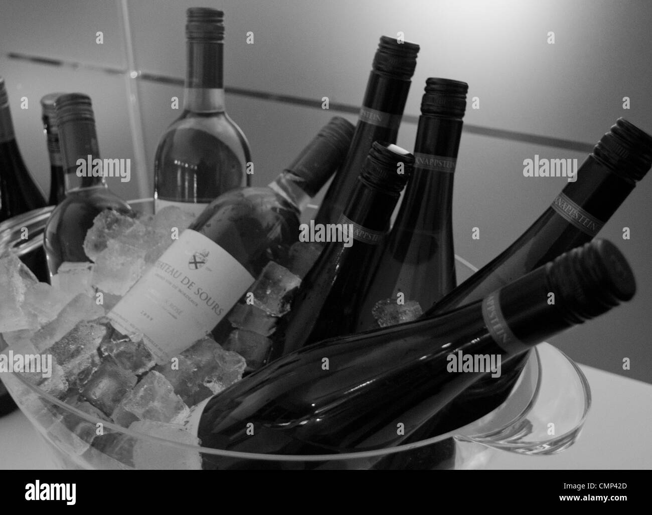 Bottles of wine chilling over ice. Stock Photo