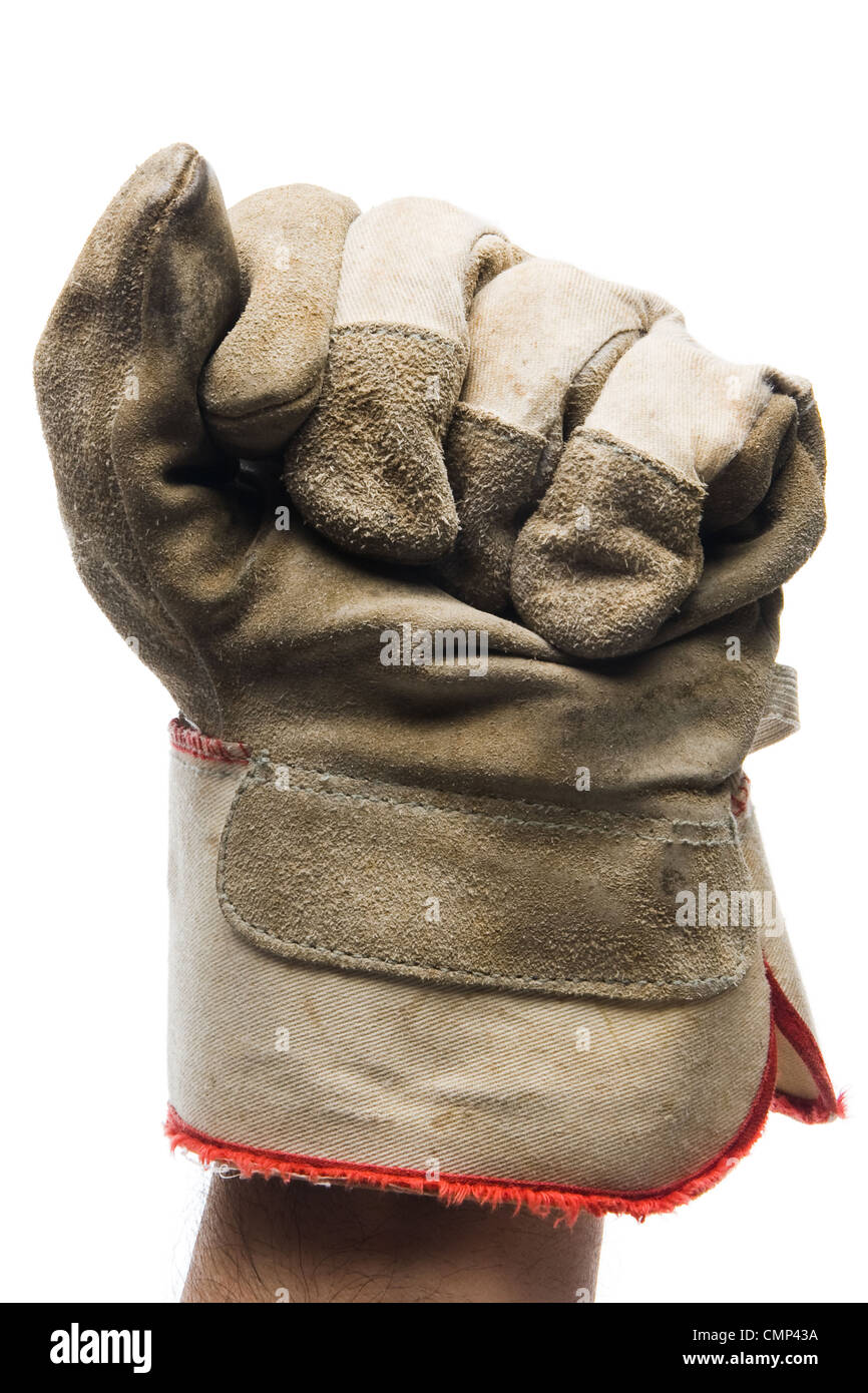 Close-up of worn canvas work glove on raised fist, against white background. Vertical-orientation. Stock Photo