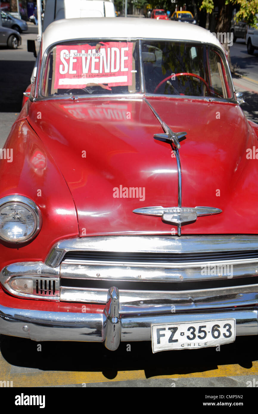 Santiago Chile,Providencia,Avenida Rancagua,car,1950s,Chevrolet,sedan,display case sale,sign,hood ornament,chrome bumper,headlight,red,classic,Latin A Stock Photo