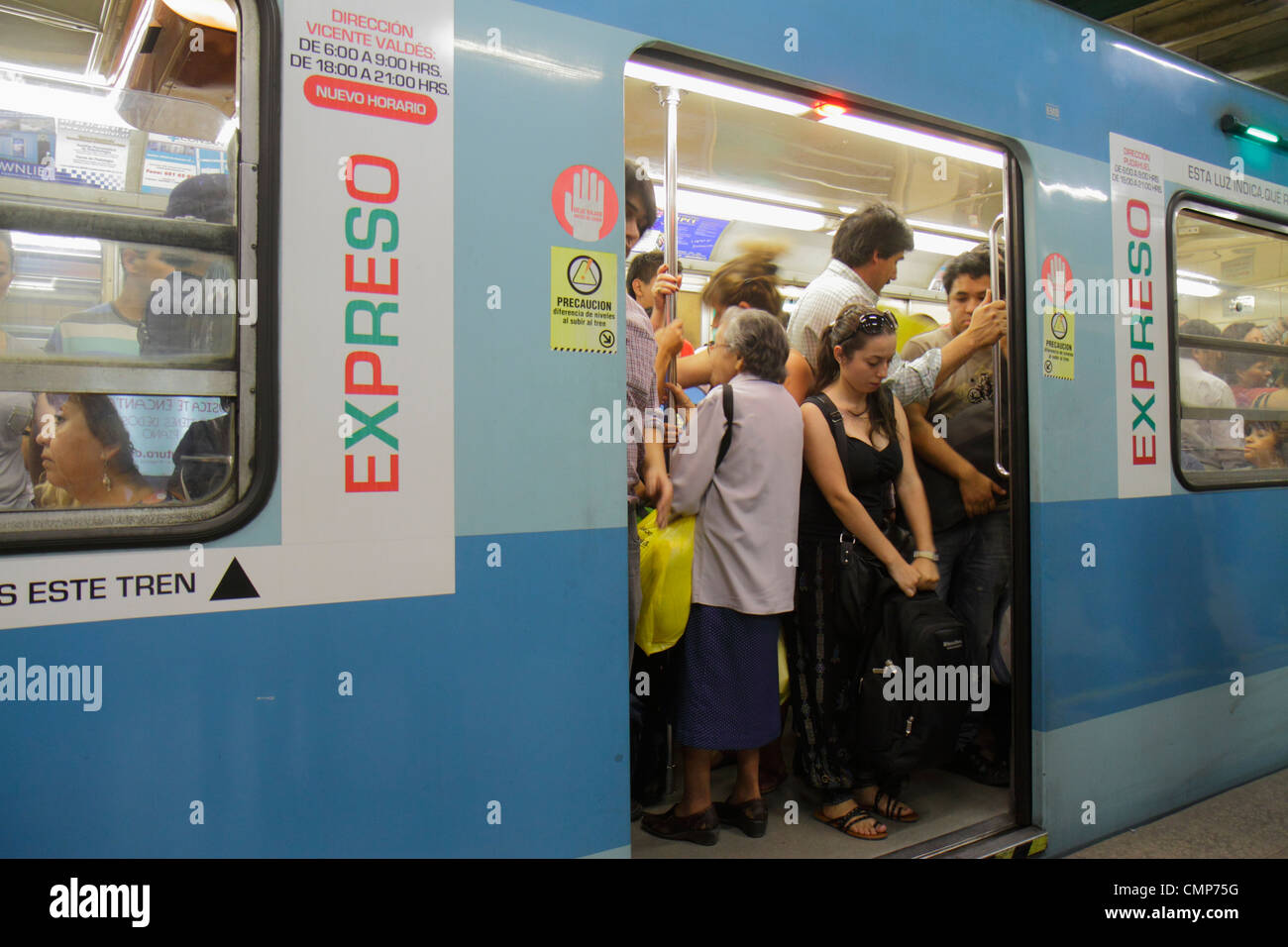 Santiago Chile,Metro de Santiago,Red Line,express train,stopped,Hispanic man men male,woman female women,senior seniors citizen citizens,standing,plat Stock Photo