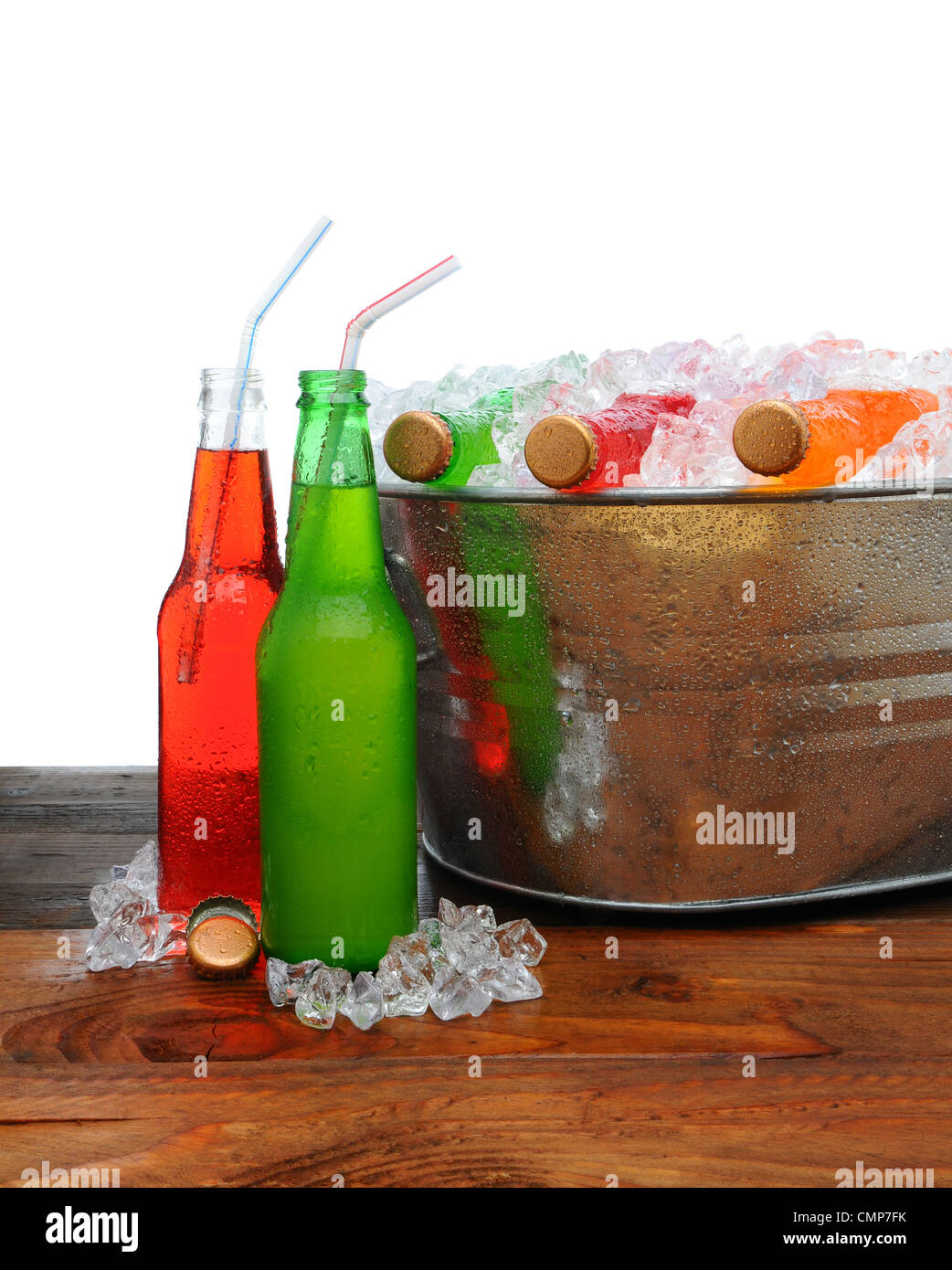 A metal party bucket on a wooden table full of cold soda pop. Stock Photo