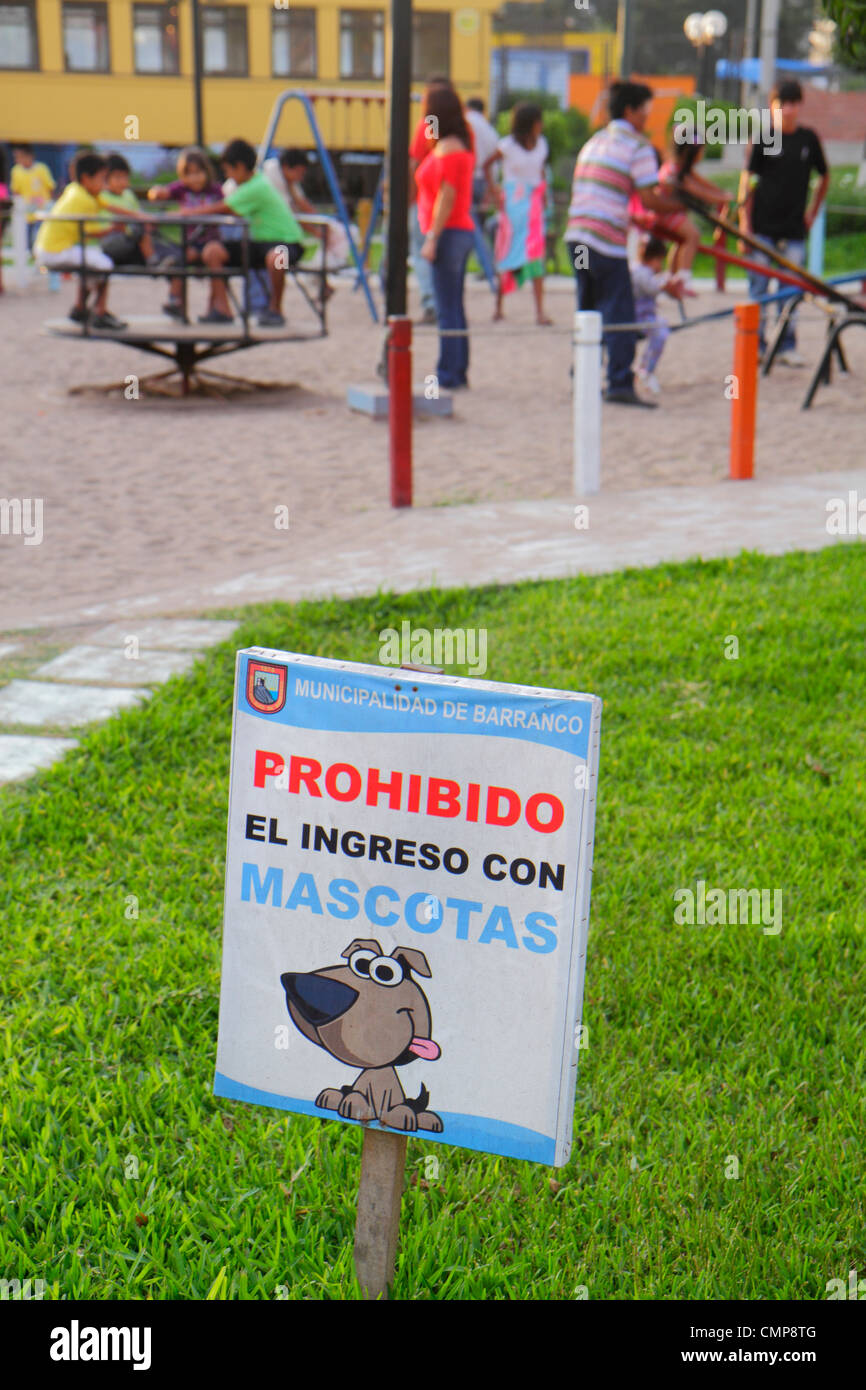 Lima Peru,Barranco District,Avenida Miguel Grau,Parque Municipal,public park,playground,grass,sign,information,Spanish,no dogs,pets,prohibit,use guide Stock Photo