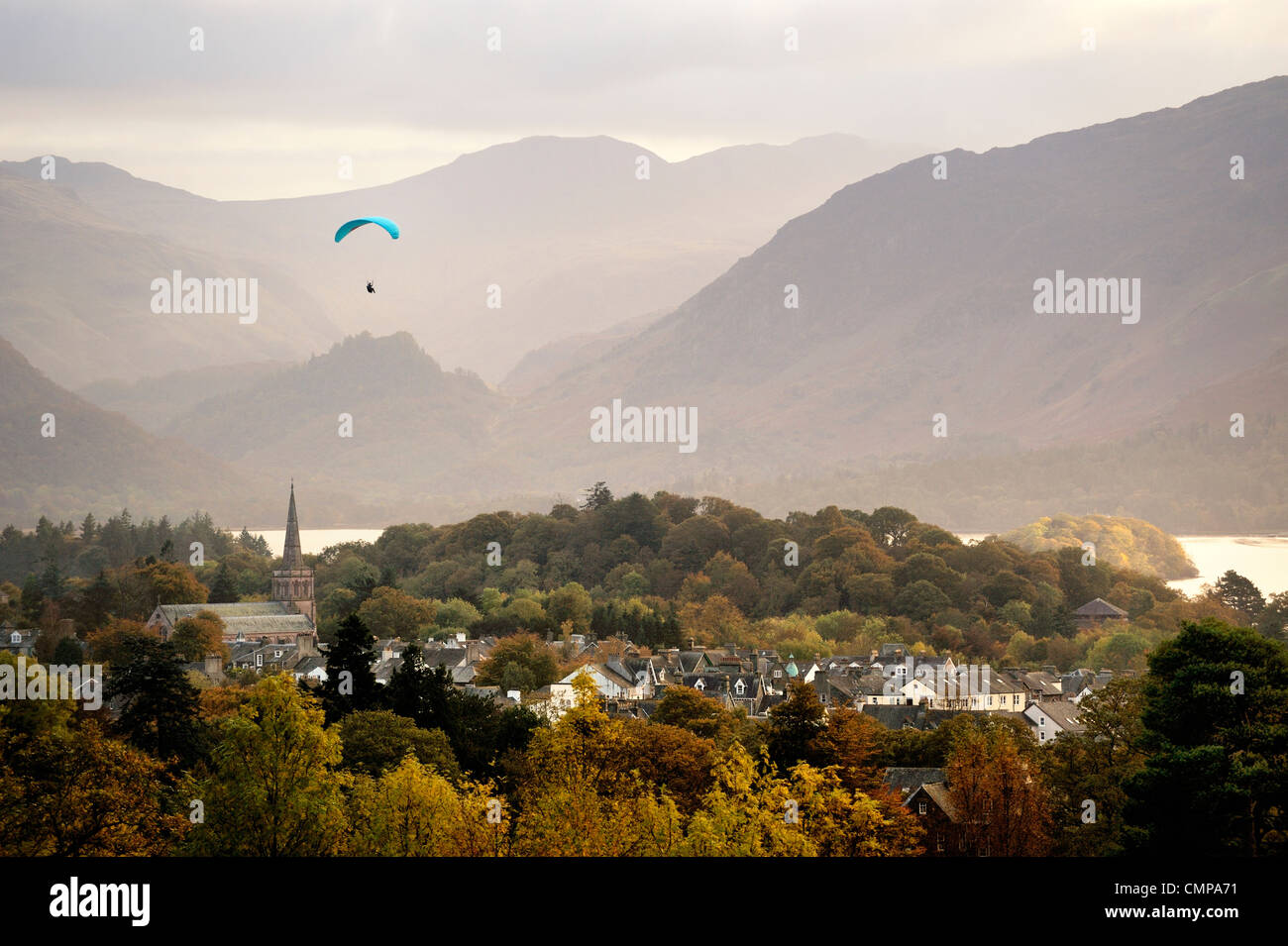 Lake District National Park, Cumbria, England. Paraglider over Keswick town and Derwentwater. South toward Borrowdale. Autumn Stock Photo