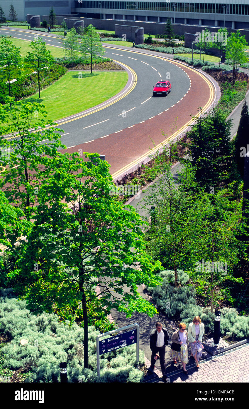 Approach service road for Terminal Two at Manchester Airport, England, showing landscaping, tree and shrub planting, paving work Stock Photo