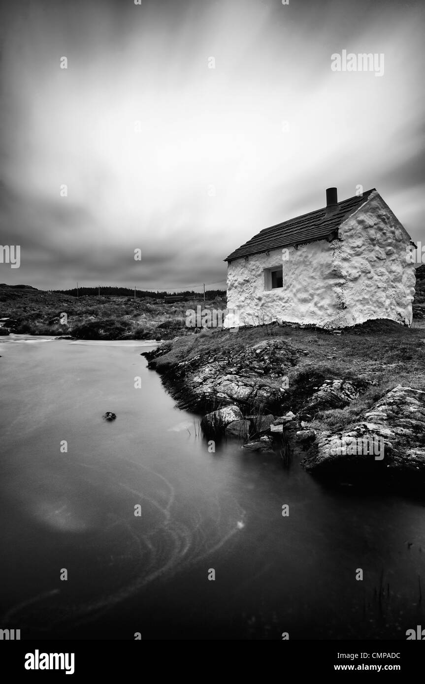 Cloudy grey skies fishermans cottage Maam Cross Galway Ireland ultra long exposure black and white conversion B+W Stock Photo