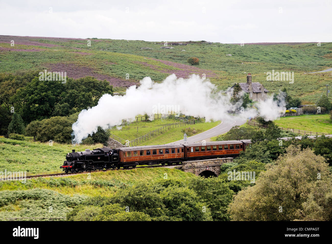 North Yorkshire Moors Railway. Vintage steam locomotive railway engine No.80072 pulls train south from Goathland, England, UK Stock Photo