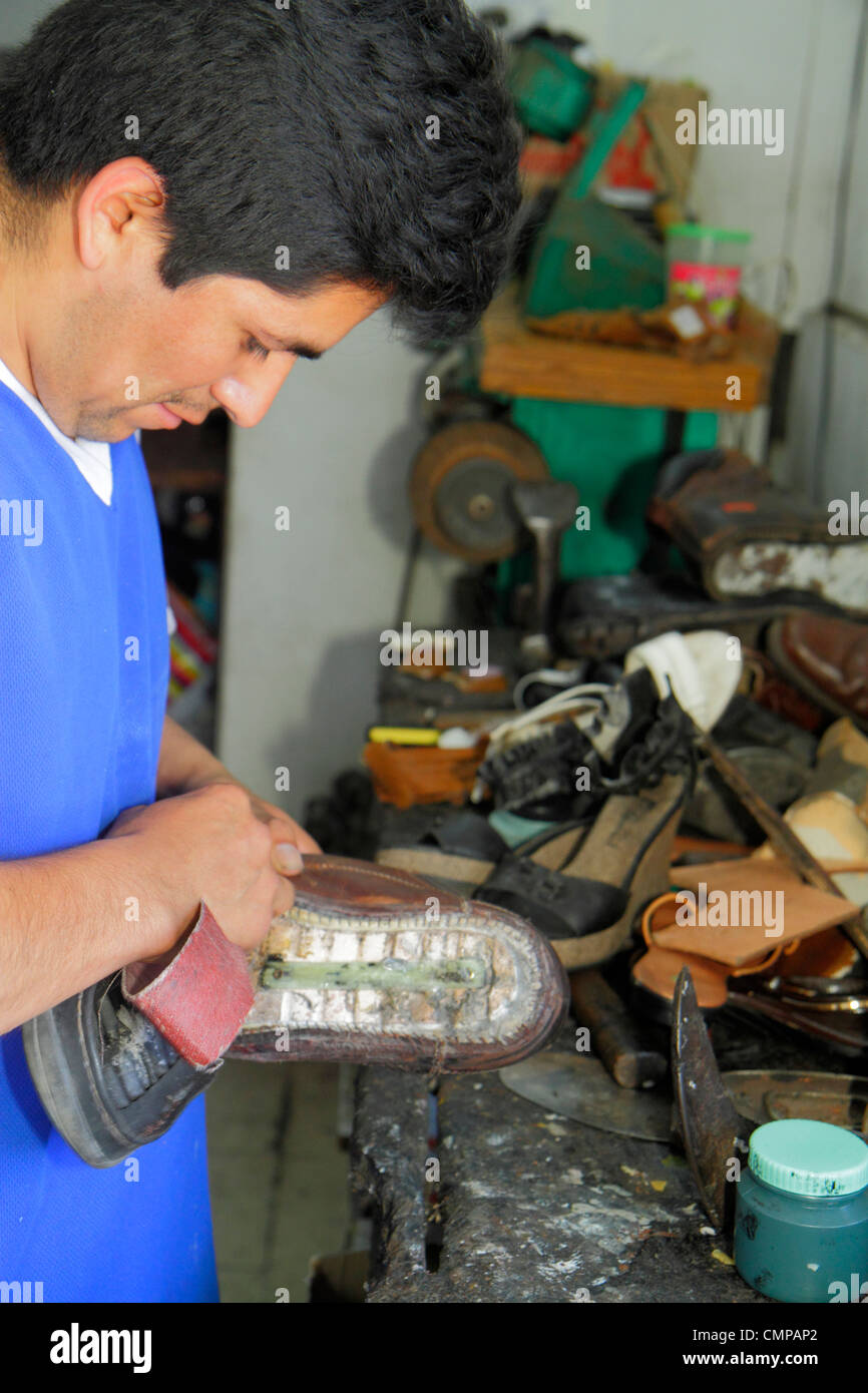 Lima Peru,Barranco,Avenida Pierola,shoe repair,cobbler,shop,Hispanic man men male adult adults,trade,tool,workbench,sole,working,work,Peru120117007 Stock Photo
