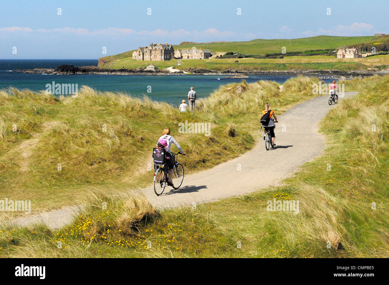 Cycling the Runkerry Trail to the Giants Causeway at Portballintrae strand near Bushmills and Portrush, Northern Ireland. Summer Stock Photo