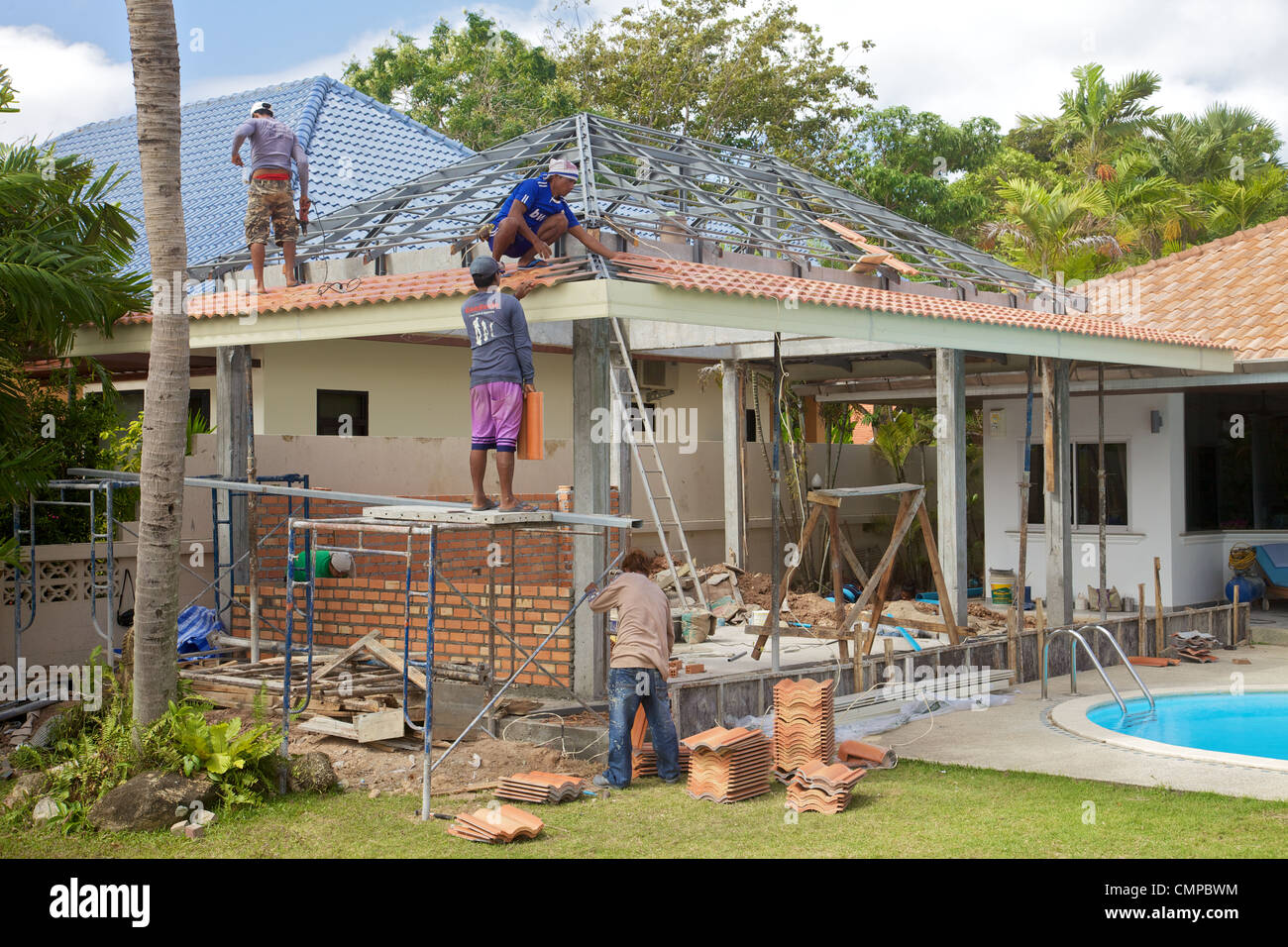 Burmese builders working on a house in Phuket Thailand Stock Photo Alamy