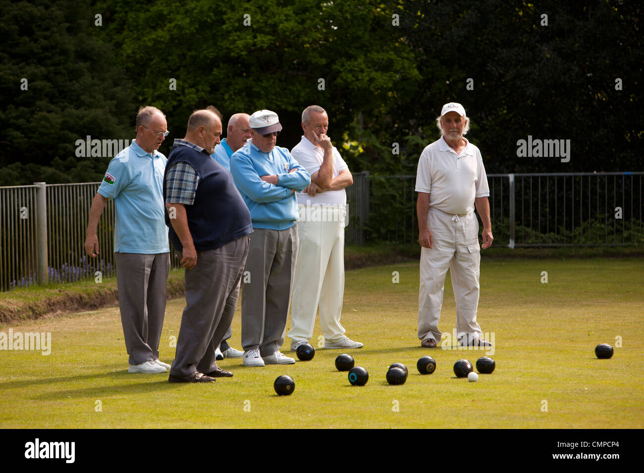 UK, Wales, Swansea, Cwmdonkin Park, bowling green, men playing bowls looking at the jack Stock Photo