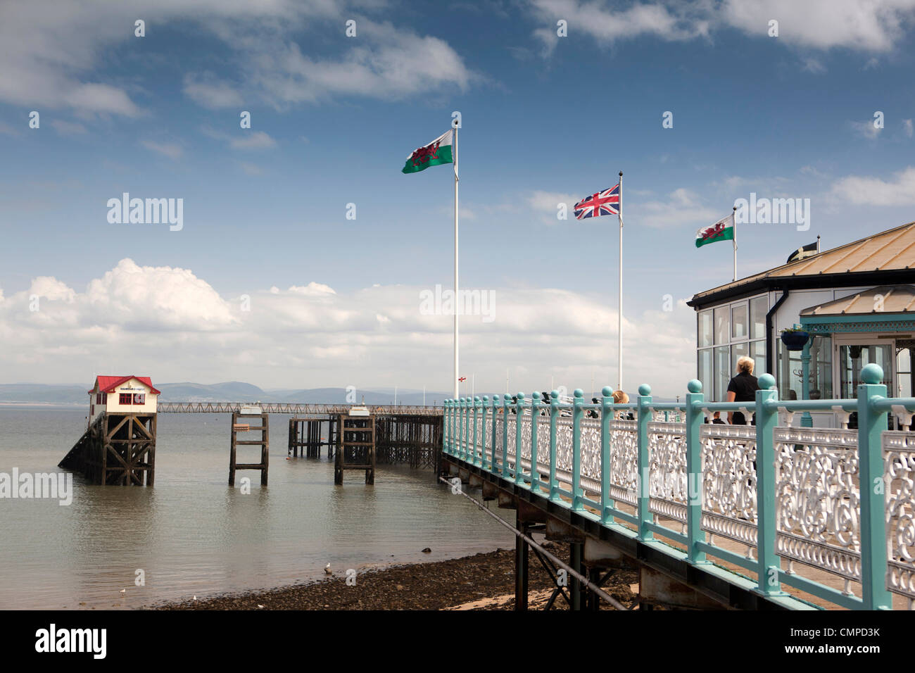 UK, Wales, Swansea, flags flying above Mumbles Pier in sunshine Stock Photo