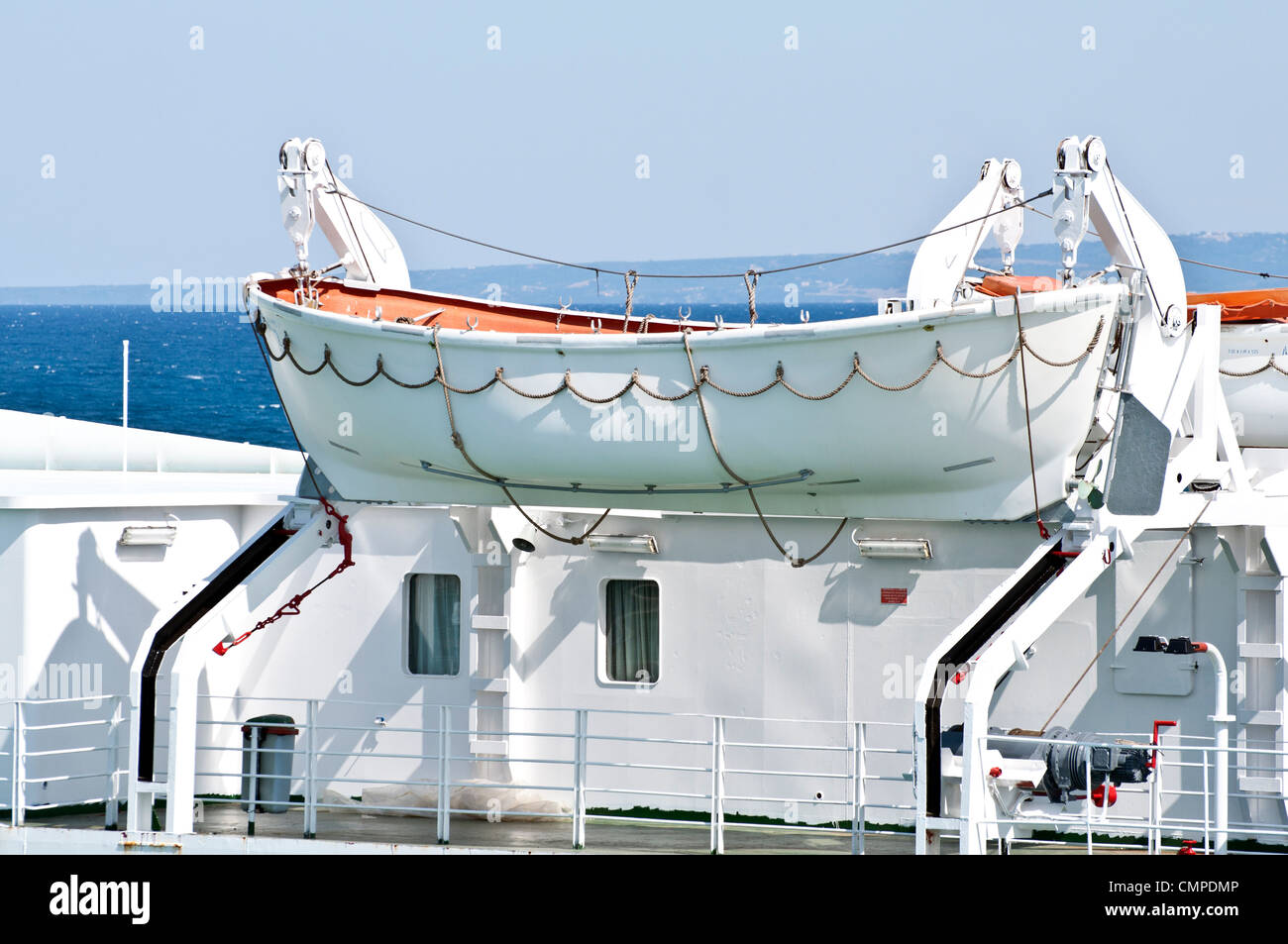 Lifeboat attached to big cruise ship for emergency cases Stock Photo