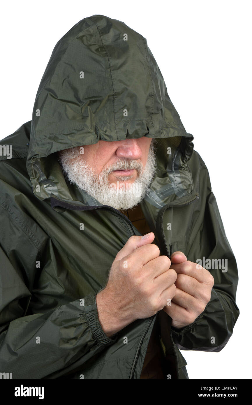 pathetic senior man in green waterproof jacket Stock Photo