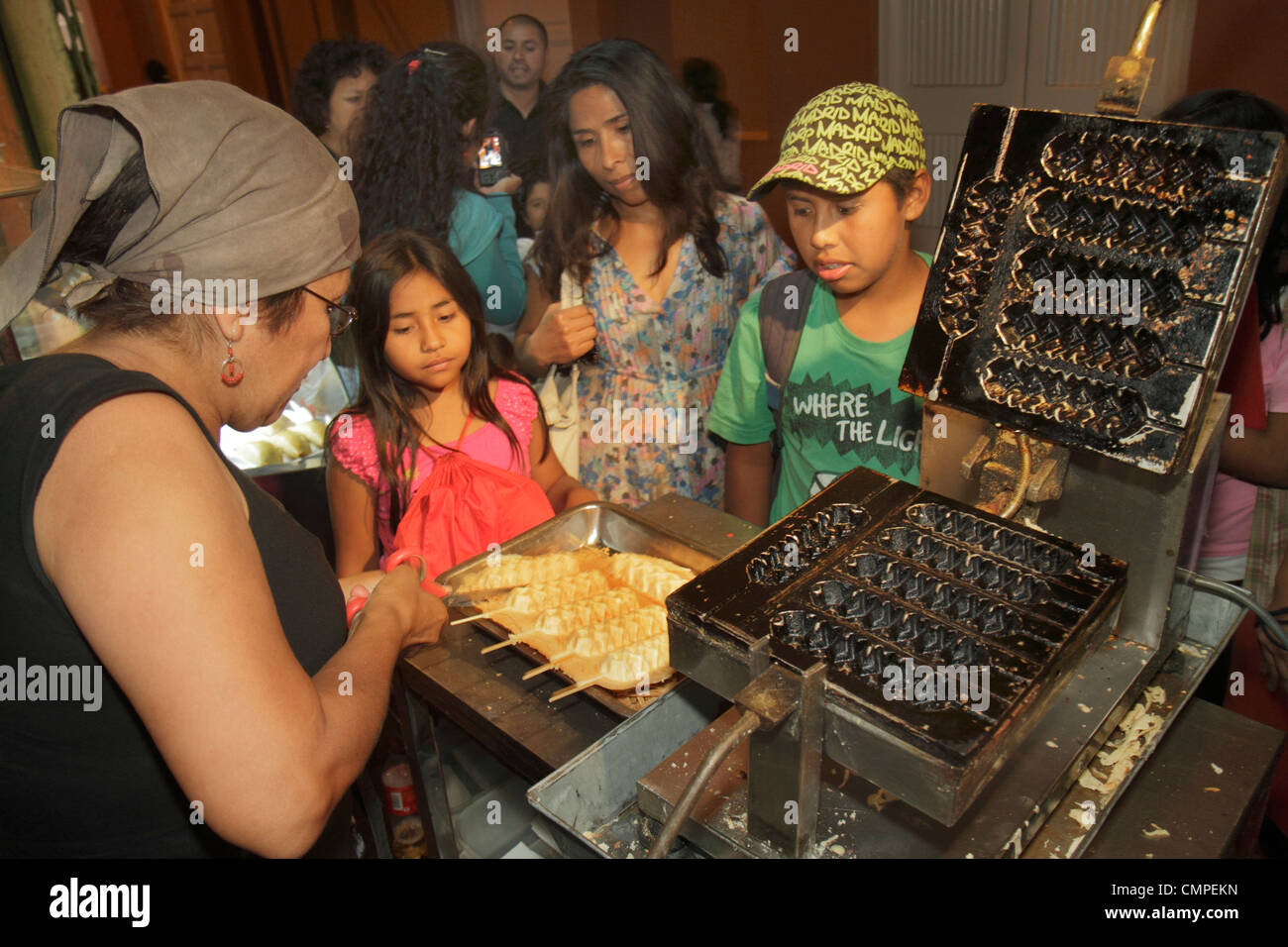 Tacna Peru,Calle Bolivar,street food,vendor vendors,stall stalls booth market buying selling,waffle on a stick,lolly waffles,dough,snack,scissors,waff Stock Photo