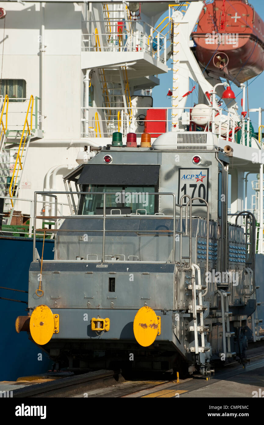 Locomotive and cargo ship at Miraflores Locks. Panama Canal Stock Photo
